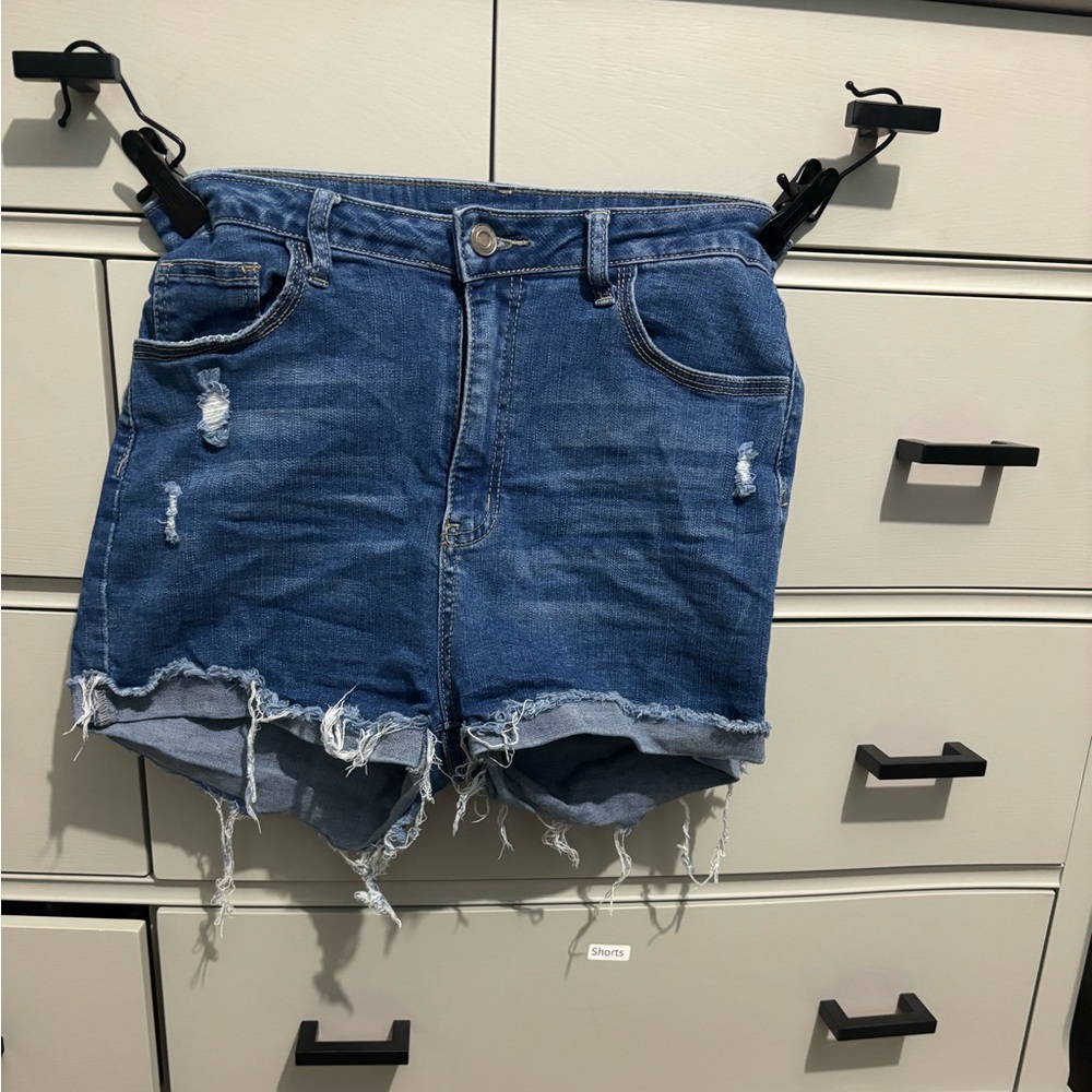 Blue jean shorts. Stretchy. Black pockets.
